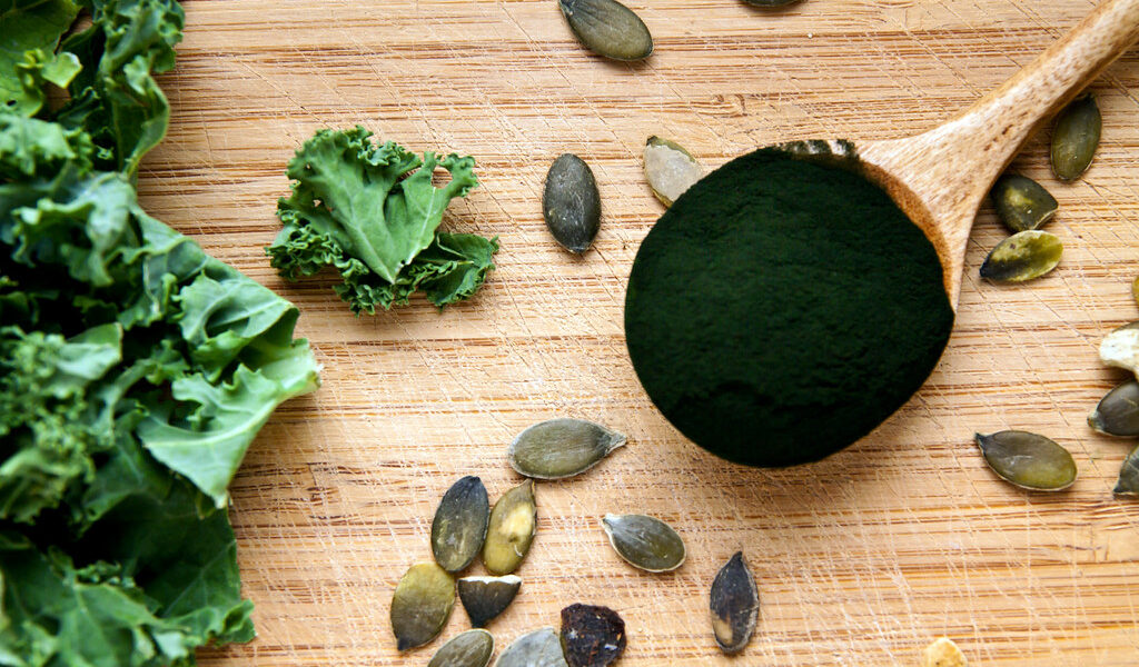 green fresh organic vegetables on wooden board